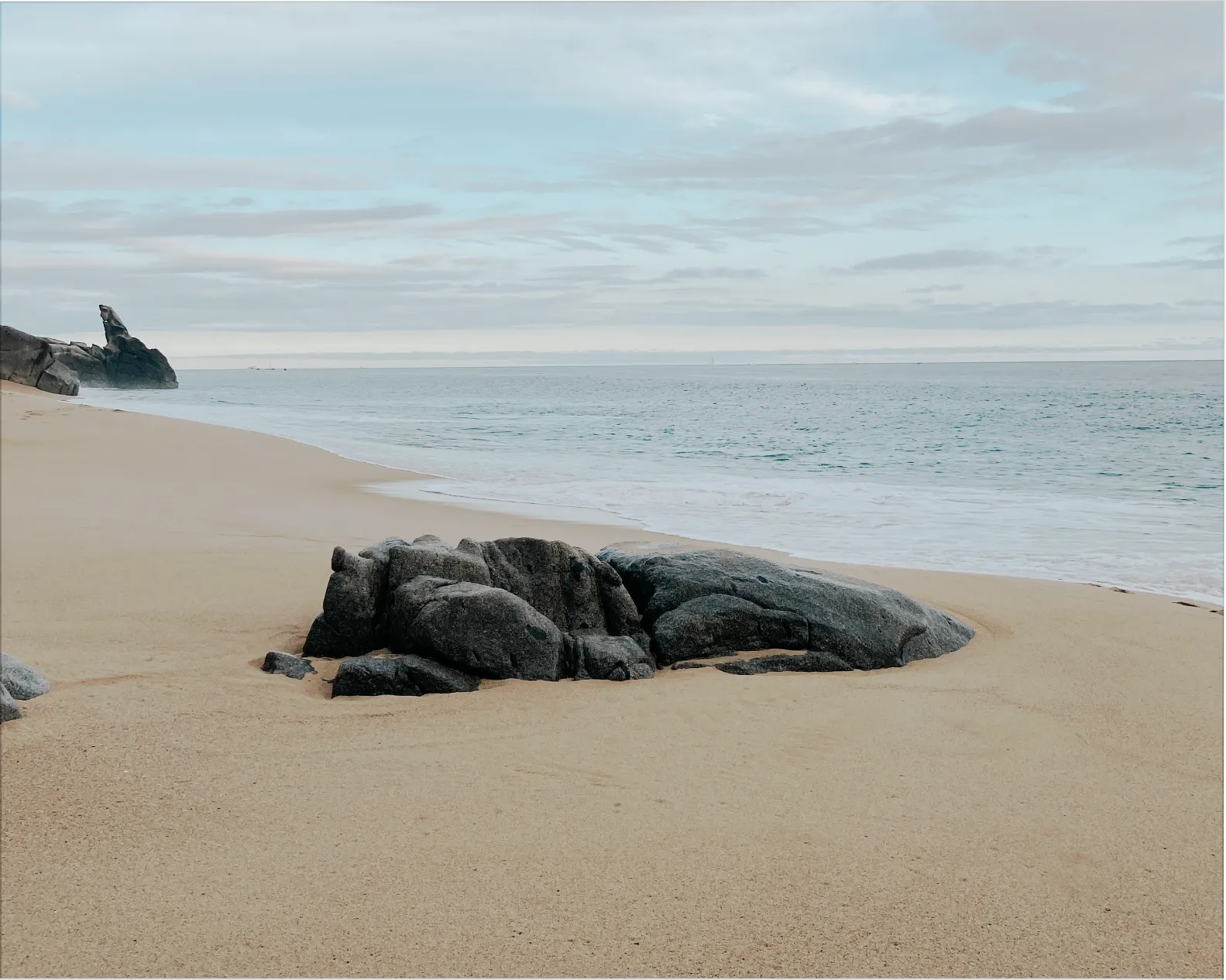 A pool surrounded by lounge chairs and palm trees.