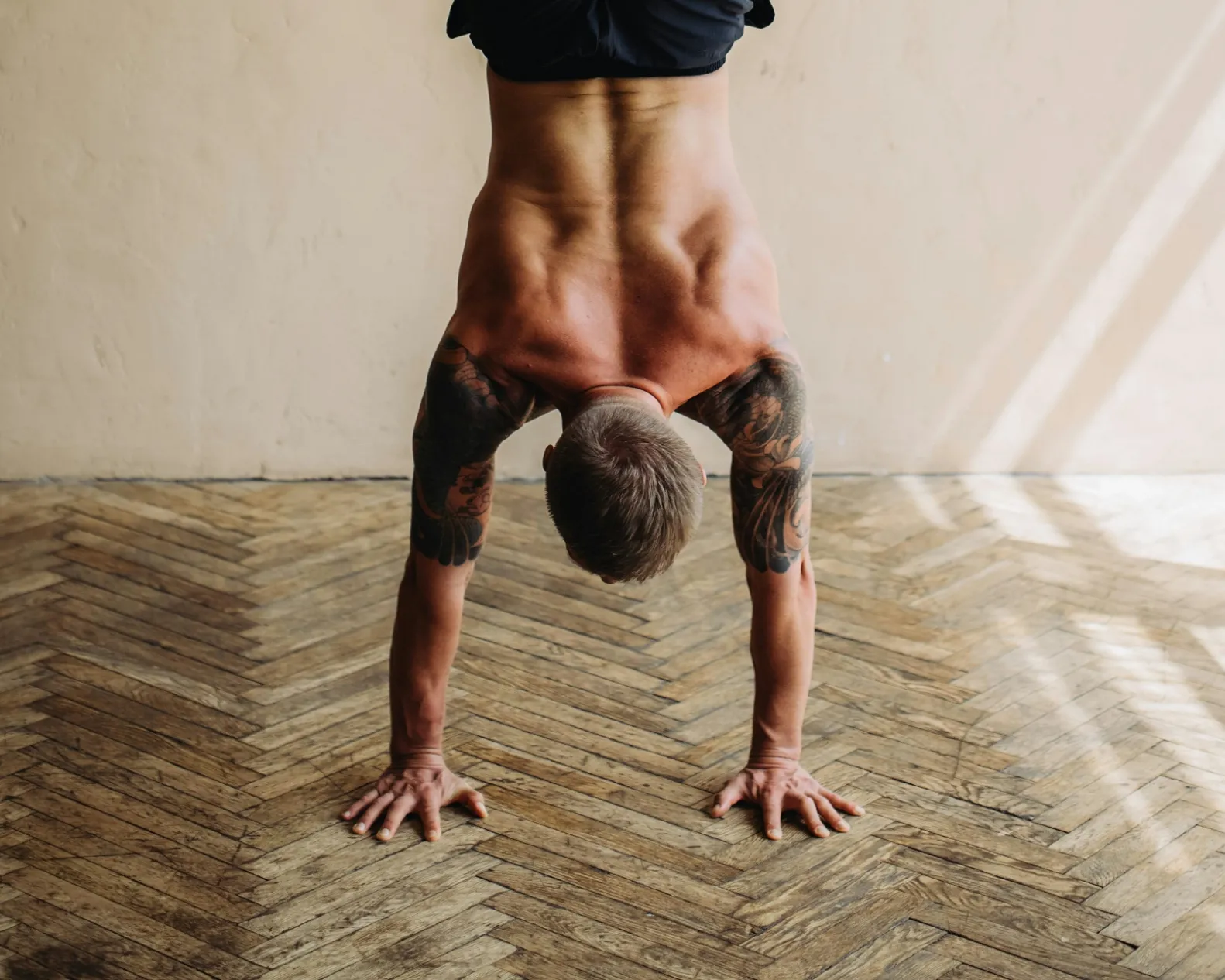 A pool surrounded by lounge chairs and palm trees.