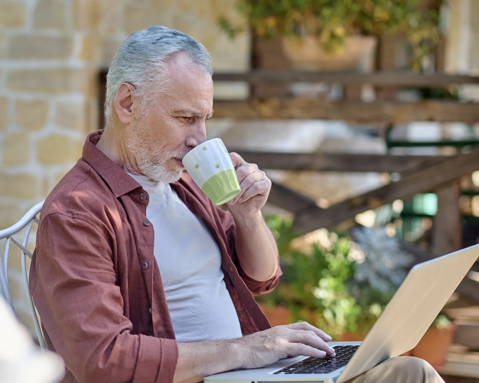 A pool surrounded by lounge chairs and palm trees.